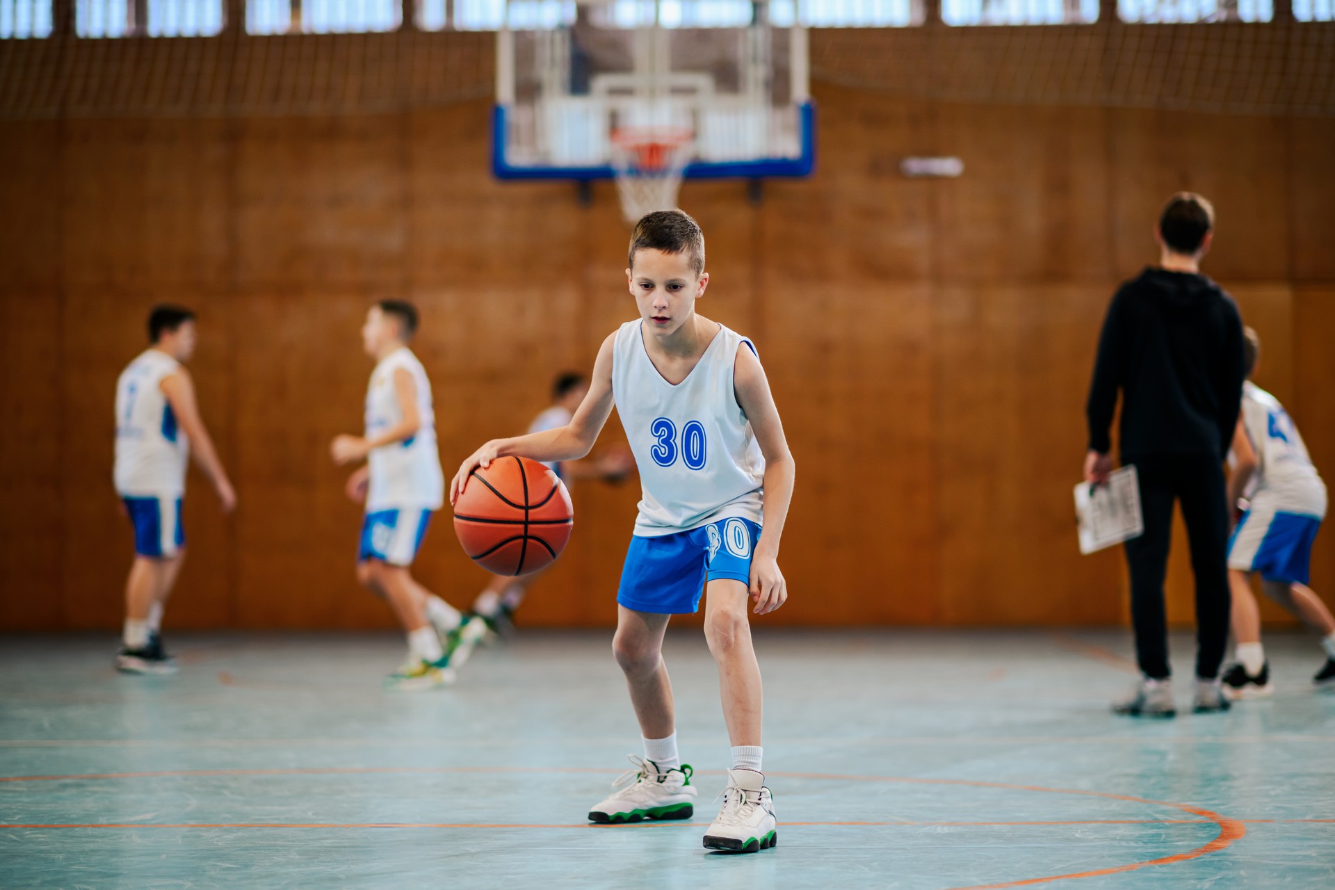 Young athlete dribbling basketball Young athlete dribbling basketball